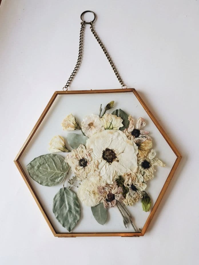 pressed flower and leaves from a bridal bouquet in a hexagon floating frame